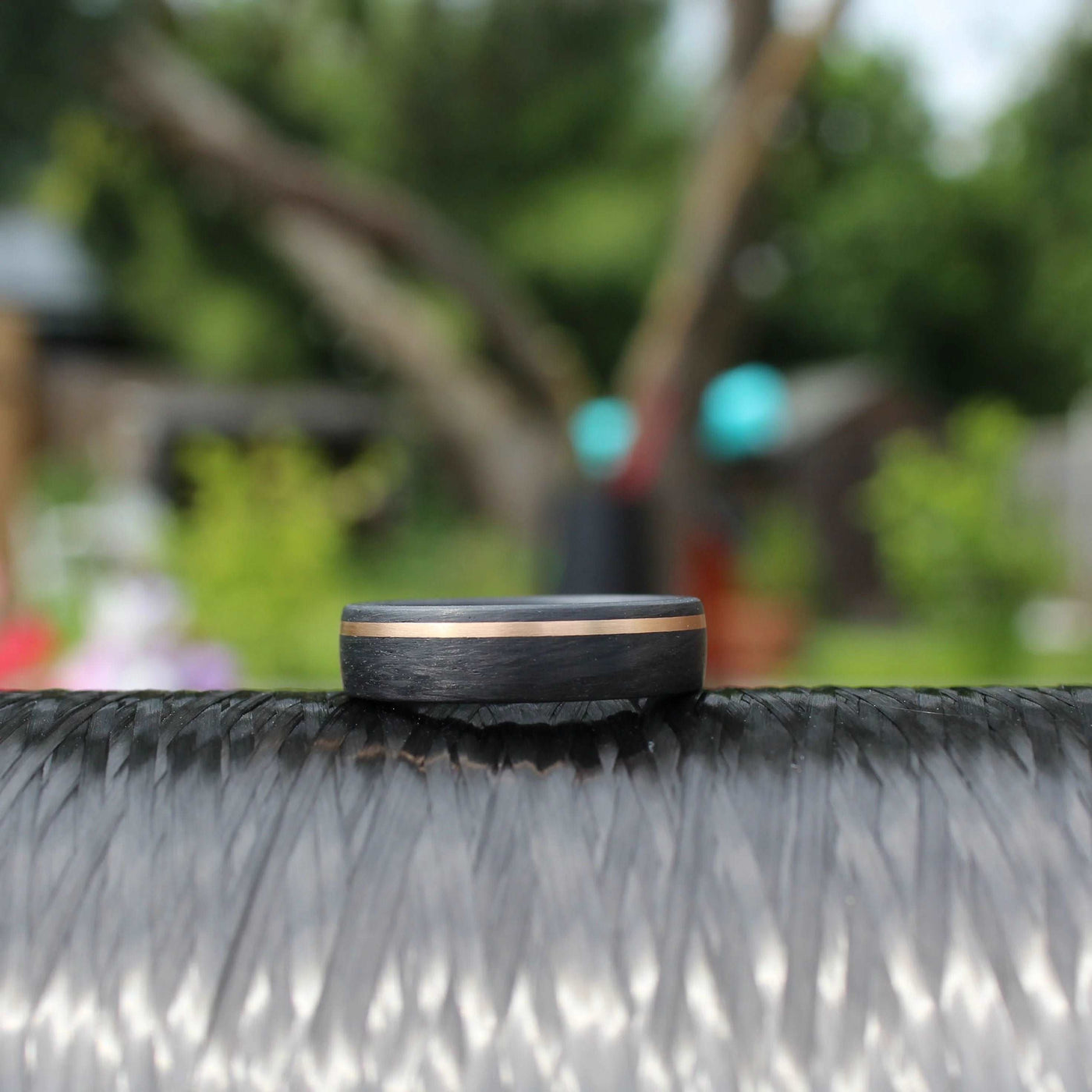 carbon fibre black wedding ring band 6mm with a gold inlay. brushed finish 6mm wide court