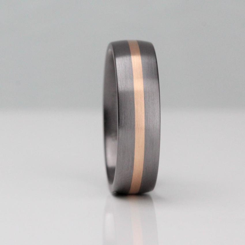6mm wide tantalum wedding ring. With a 2mm central stripe of rose gold. Tantalum has a gunmetal colour. court shape