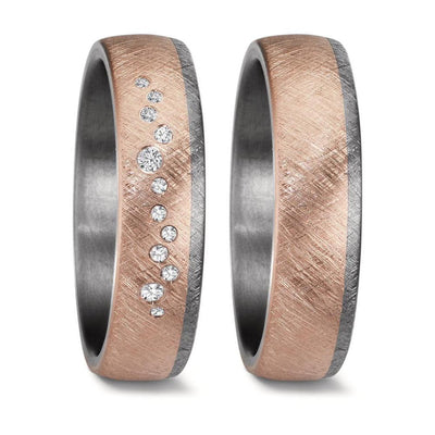 Matching wedding ring set crafted from tantalum and 14K rose gold in a unique swirl design. The men's ring features a comfort-fit band with three-quarters of the ring showcasing matte-finish rose gold, seamlessly flowing into a brushed tantalum section. The women's ring mirrors this striking design and is elegantly adorned with 12 sparkling diamonds set into the rose gold, adding a touch of brilliance to the modern contrast.