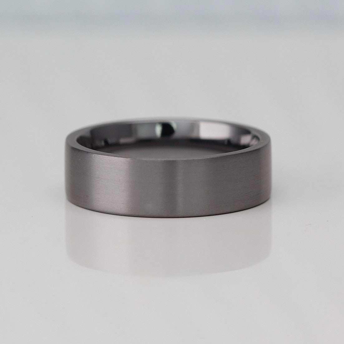 Flat court wedding ring band in brushed tantalum 7mm wide with a comfort fit inside