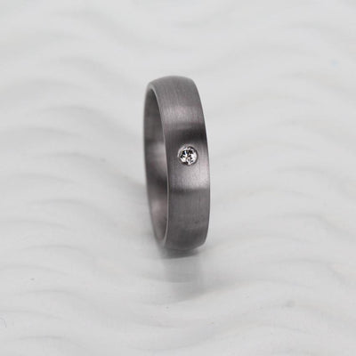 Tantalum wedding ring band for woman with a diamond in brushed satin finish